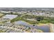Drone shot of neighborhood featuring various ponds and dense landscaping at 6028 Milestone Dr, Apollo Beach, FL 33572