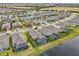 Wide aerial view of a residential community featuring screened pools and beautiful landscaping near a scenic pond at 6028 Milestone Dr, Apollo Beach, FL 33572