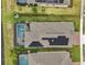 Overhead view of a property featuring a pool, spa, screened enclosure and solar panels on the roof at 6028 Milestone Dr, Apollo Beach, FL 33572