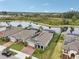 Aerial view of a home with well-manicured lawn and water views at 6028 Milestone Dr, Apollo Beach, FL 33572