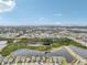 Expansive aerial view showcasing the community, serene lakes, and distant city skyline with clear blue skies at 6028 Milestone Dr, Apollo Beach, FL 33572