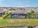 Backyard view highlighting a screened pool, spa, and well-maintained fenced yard, perfect for outdoor enjoyment at 6028 Milestone Dr, Apollo Beach, FL 33572