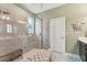 Shower with decorative glass panel in bathroom with tiled shower and tiled floors at 6028 Milestone Dr, Apollo Beach, FL 33572