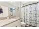 Bathroom featuring a granite vanity, white cabinets, nautical themed shower curtain at 6028 Milestone Dr, Apollo Beach, FL 33572