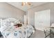 Cozy bedroom features a white bed frame with seashell patterned bedding and a ceiling fan at 6028 Milestone Dr, Apollo Beach, FL 33572
