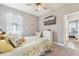 Bedroom with a ceiling fan, dresser, wall-mounted television, and view into another bedroom at 6028 Milestone Dr, Apollo Beach, FL 33572