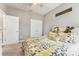 Bedroom featuring a ceiling fan, yellow floral bedding and soft gray walls at 6028 Milestone Dr, Apollo Beach, FL 33572