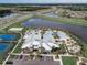 Aerial view of community amenities including a clubhouse, pools, sports courts, and beautifully landscaped grounds at 6028 Milestone Dr, Apollo Beach, FL 33572