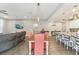 Open-concept kitchen with bar seating, stainless appliances, and modern lighting at 6028 Milestone Dr, Apollo Beach, FL 33572