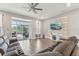 Cozy living room with modern furniture, a decorative wall, and sliding glass doors to the outdoors at 6028 Milestone Dr, Apollo Beach, FL 33572