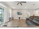 Spacious living room features wood-look floors, a large window, and comfortable seating at 6028 Milestone Dr, Apollo Beach, FL 33572