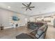 Open-concept living room with a large sofa, adjoining kitchen, and stylish wood-look floors at 6028 Milestone Dr, Apollo Beach, FL 33572