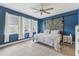 This main bedroom with a decorative barn door headboard has blue walls and carpeted floor at 6028 Milestone Dr, Apollo Beach, FL 33572