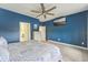 This main bedroom is painted with blue walls and includes a wall-mounted television at 6028 Milestone Dr, Apollo Beach, FL 33572