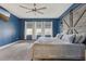 Main bedroom with blue walls, carpeted floor and lots of natural light from the windows at 6028 Milestone Dr, Apollo Beach, FL 33572