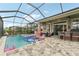 Inviting screened in pool and spa with outdoor seating and entertainment area at 6028 Milestone Dr, Apollo Beach, FL 33572