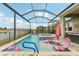 Screened-in pool area with hot tub, lounge chairs, and peaceful waterfront views at 6028 Milestone Dr, Apollo Beach, FL 33572