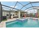 Relaxing pool and spa with lake views from the screened lanai at 6028 Milestone Dr, Apollo Beach, FL 33572