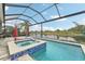 Inviting pool and spa with scenic lake views in a screened enclosure at 6028 Milestone Dr, Apollo Beach, FL 33572