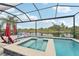 Sparkling pool and spa with scenic lake views in a screened enclosure at 6028 Milestone Dr, Apollo Beach, FL 33572