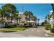 Gated entrance to community with lush landscaping and palm trees at 6650 Sunset Way # 210, St Pete Beach, FL 33706