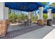 Covered seating area with tables and chairs near the pool at 7914 Hampton Lake Dr, Tampa, FL 33647