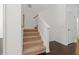 Carpeted staircase with wooden railing at 7914 Hampton Lake Dr, Tampa, FL 33647