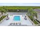 Community pool with lounge chairs and patio tables at 8829 Bay Pointe Dr # 205, Tampa, FL 33615