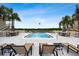 Community pool with lounge chairs and patio tables at 8829 Bay Pointe Dr # 205, Tampa, FL 33615