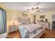 Second bedroom with hardwood floors and ceiling fan at 9209 Seminole Blvd # 209, Seminole, FL 33772