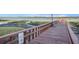 Wooden pier extending into calm water with no swimming sign at 9209 Seminole Blvd # 209, Seminole, FL 33772