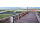 Wooden pier extending into calm water with no swimming sign at 9209 Seminole Blvd # 209, Seminole, FL 33772