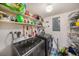 Stacked washer and dryer in a well-lit laundry room with ample storage shelves at 9209 Seminole Blvd # 209, Seminole, FL 33772