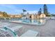 Community pool with lounge chairs and surrounding buildings at 9209 Seminole Blvd # 209, Seminole, FL 33772