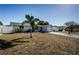 House exterior showcasing a palm tree and a spacious front yard at 11214 Glover Rd, Port Richey, FL 34668