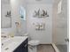 Clean bathroom with white vanity, walk-in shower, and nautical decor at 1217 De Narvaez Ave, Bradenton, FL 34209