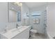 Clean bathroom with tub shower, vanity, and floating shelves at 1217 De Narvaez Ave, Bradenton, FL 34209