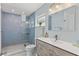 Modern bathroom with walk-in shower, floating vanity, and stylish light fixtures at 1217 De Narvaez Ave, Bradenton, FL 34209