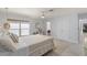Cozy bedroom with queen-size bed, built-in desk, and double doors to closet at 1217 De Narvaez Ave, Bradenton, FL 34209