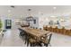 Open concept dining room with large wooden table and pool table at 1217 De Narvaez Ave, Bradenton, FL 34209