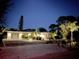 Attractive home exterior at night with landscaped yard at 1217 De Narvaez Ave, Bradenton, FL 34209