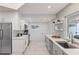 Modern kitchen with white cabinets, gray lower cabinets, and stainless steel appliances at 1217 De Narvaez Ave, Bradenton, FL 34209