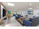 Bright living room with comfy seating, large TV, and sliding glass doors leading to patio at 1217 De Narvaez Ave, Bradenton, FL 34209