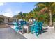 Outdoor fire pit area with teal chairs near the pool at 1217 De Narvaez Ave, Bradenton, FL 34209