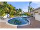 Refreshing kidney shaped pool surrounded by lush landscaping at 1217 De Narvaez Ave, Bradenton, FL 34209