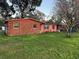 Red brick home showcasing a large grassy area at 12801 Carlton Rd, Thonotosassa, FL 33592