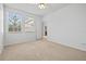 Bedroom with ceiling fan, double closet, and neutral carpeting at 14545 Mirabelle Vista Cir, Tampa, FL 33626
