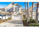 Inviting exterior of a two-story townhome with a two-car garage and palm trees at 14545 Mirabelle Vista Cir, Tampa, FL 33626