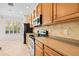 Kitchen features wood cabinets, stainless steel appliances, and tile floors at 14545 Mirabelle Vista Cir, Tampa, FL 33626