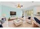 Light and airy living room featuring comfortable seating and a large TV at 14545 Mirabelle Vista Cir, Tampa, FL 33626